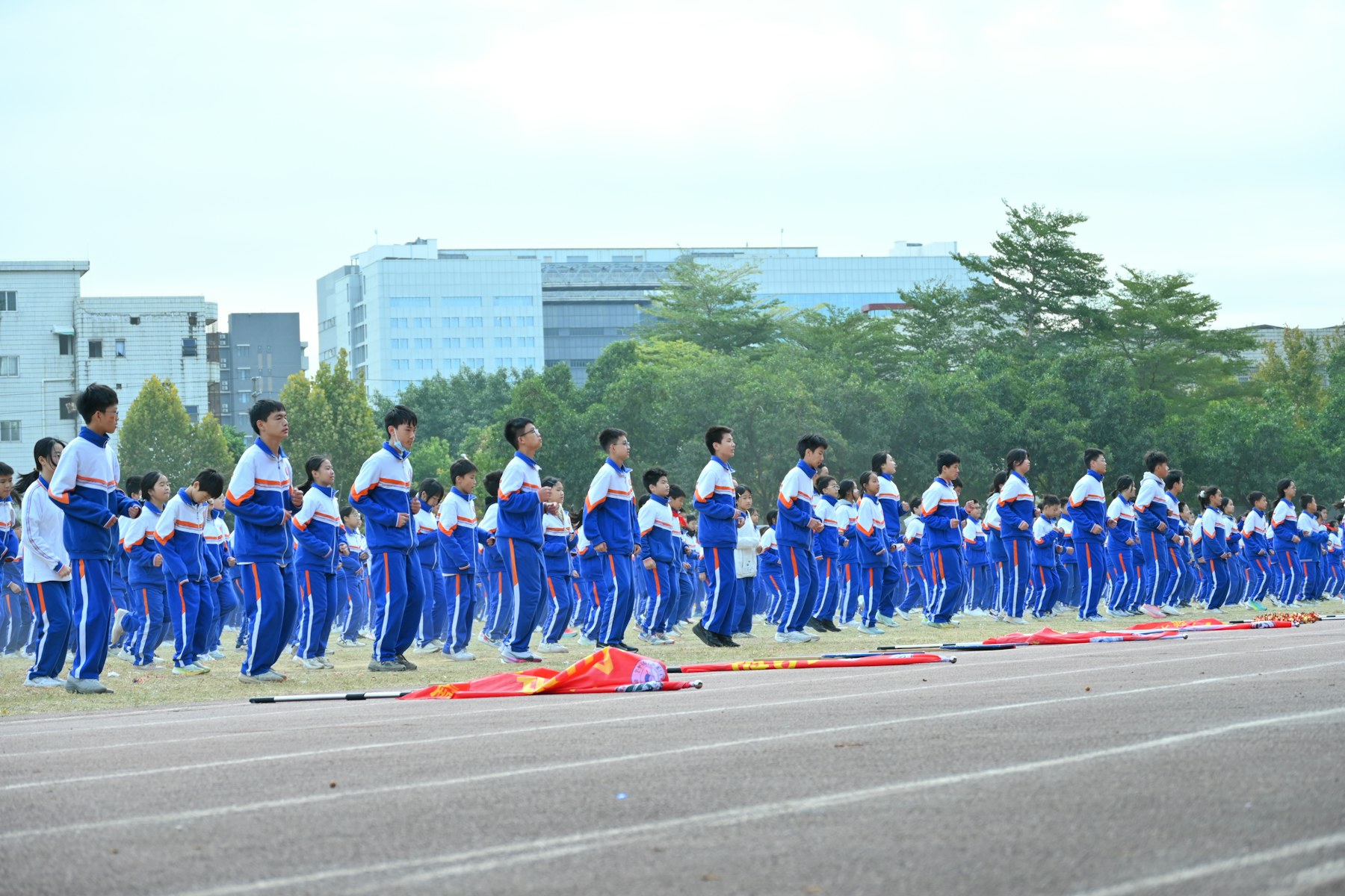 Students exercise together on an outdoor track.